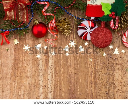 Christmas Decoration Over Wooden Background. Beige paper  card background with Christmas border