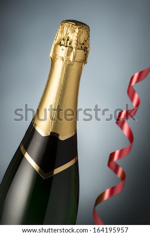 Bottle of champagne, serpentine  closeup. Celebration. New Year Card Design with Champagne. Christmas Scene.