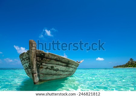 Perfect tropical island paradise beach and old boat