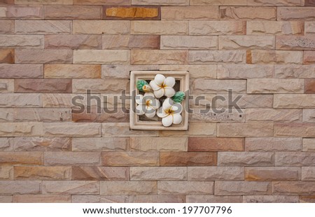 Stone tiles, walls decorated with flowers, plaster statue.