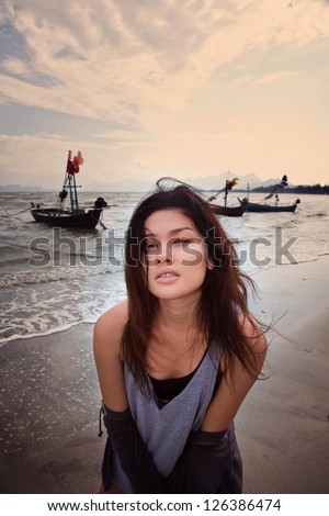 Asian woman on a background of fishing boats