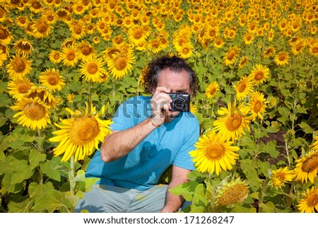 Man shoots at the camera sunflowers in the field