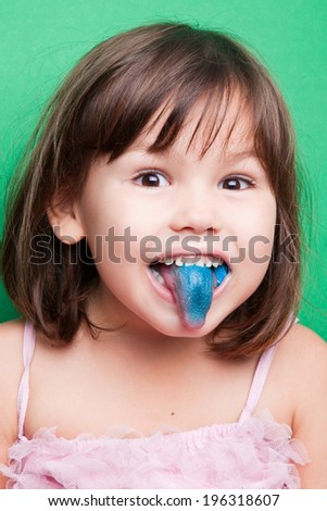 Girl with a blue tongue on food dyes