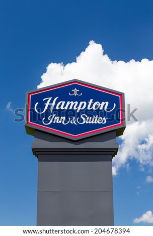 BLOOMINGTON, MN/USA - JUNE 24, 2014: Hampton Inn and Suites sign. Hampton Inn and Suites is a brand of independently owned hotels trademarked by Hilton Worldwide.