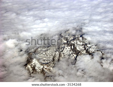 over the alps with drifting clouds and snow