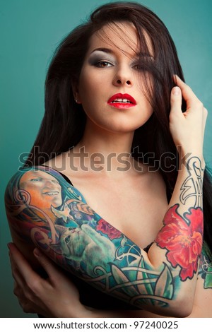 Beautiful sexy glamorous girl with tattoos.red.