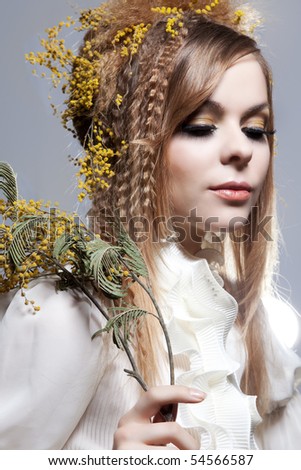 fashion portrait with great hairstyle with mimosa flowers