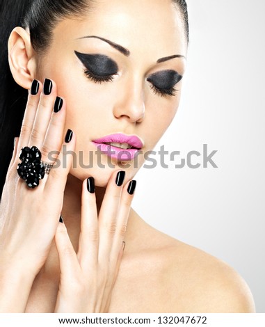 Face of the  beautiful sexy  woman with black nails and pink lips. Sexy girl with fashion makeup