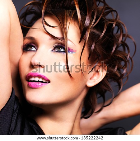 Beautiful sexy woman with bright pink makeup and stylish fashion hairstyle - posing at studio.