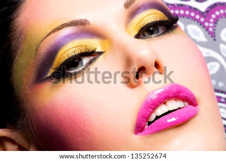Closeup face of beautiful woman with fashion bright makeup