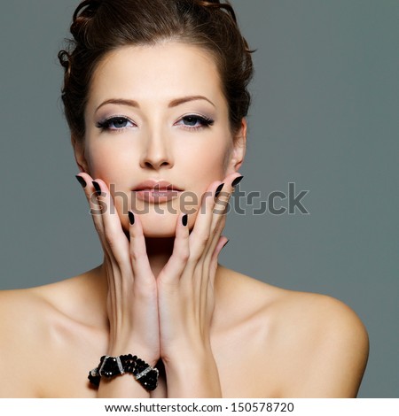 glamour sexy young  female with black nails and  eye make-up. Front portrait