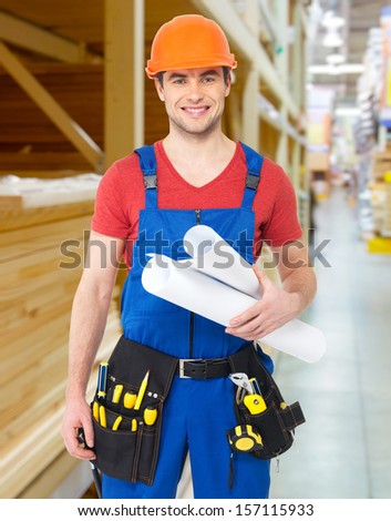 Portrait of smiling handyman with tools and paper