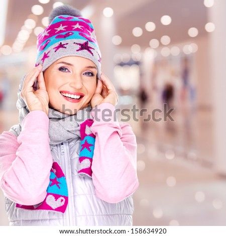 Photo of a happy smiling woman in winter clothes with bright positive emotions - indoors