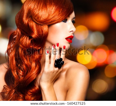Beautiful sensual woman with long red hairs and red nails -   over art blink night lights
