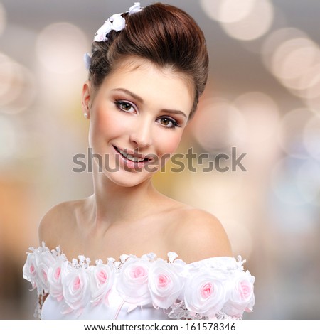 Portrait of beautiful smiling  bride in wedding dress over art background