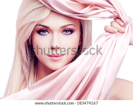 Portrait of a beautiful sexy tender woman with pink silk posing at studio isolated on white.