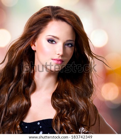 Beautiful sexy woman with brown long hairs over art background