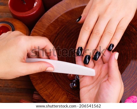 Manicurist master  makes manicure on woman\'s hands - Spa treatment concept