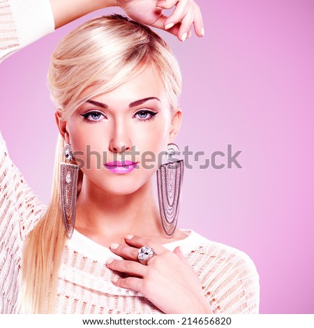 Portrait of beautiful woman with bright pink lips over pink background