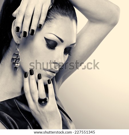 Woman with black nails and with stylish bijouterie. Black or white image concept