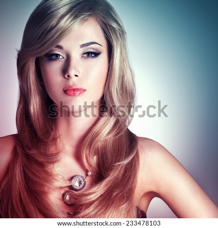 Portrait of a beautiful  fashion woman with bright makeup.  Pretty sexy face of a glamour girl posing at studio
