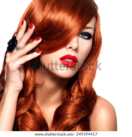 Beautiful woman with long red hairs with sexy bright lips and red nails.  Portrait of a fashion model with covered face by hairs  -  isolated on white.