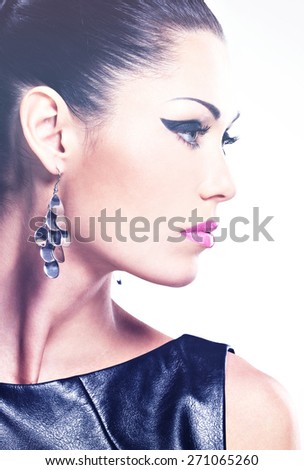 Profile face of the  beautiful sexy  woman with glamour fashion makeup of eyes and gloss hairstyle. Portrait of the caucasian adult girl at studio