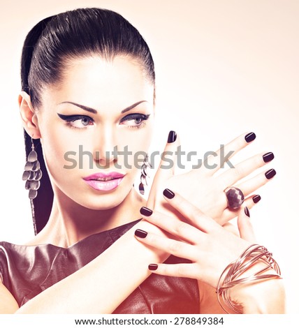 Beautiful fashion sexy woman with black nails at pretty face.