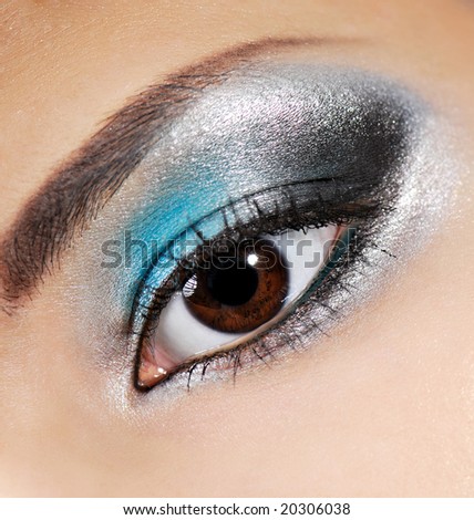 Multicolored beauty make-up on the human eyelid.