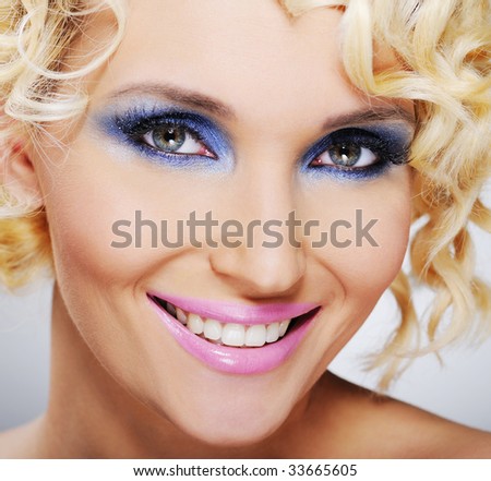 laughing beautiful female face with bright make-up - close-up