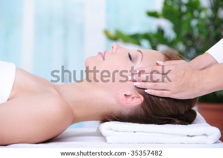Beautiful woman in the beauty salon getting a face massage