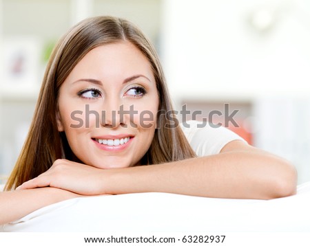 Beautiful smiling womans face looking away - indoors