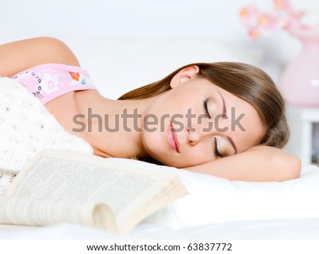 beautiful young woman sleeps on a bed in a bedroom at home