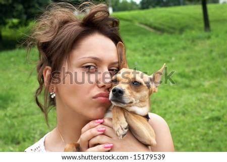 girl with little dog (toy terrier) in the park
