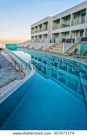 CRETE, GREECE - MAY 2015: Sunrise view on luxurious swimming pool in Greek spa hotel at Makrigialos on Crete island.