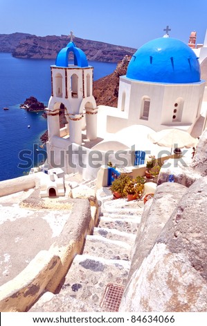 A view of a famous blue domed church from Oia on the greek isle of Santorini.