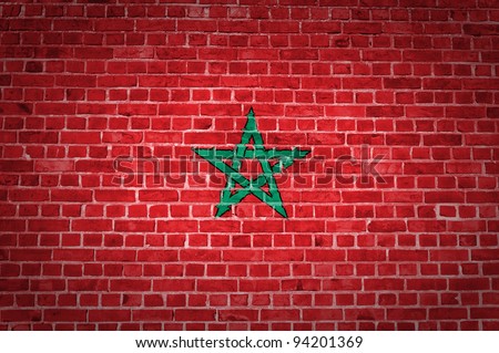 An image of the Morocco flag painted on a brick wall in an urban location