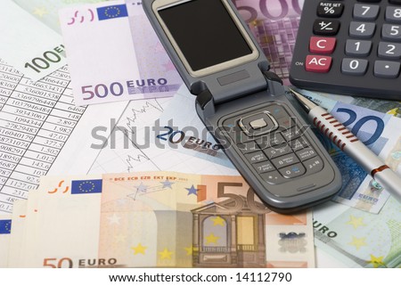 Money, calculator, graph and mobile telephone