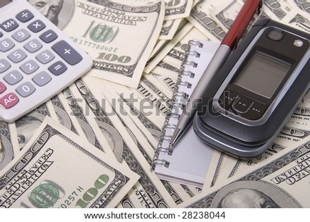 Money, calculator, pen and mobile telephone