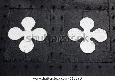 Decorative panel details on a black and white half-timbered building built in Tudor / medieval times.