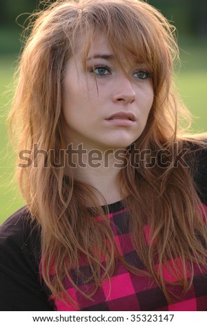 A portrait of a very pretty teenage girl, shot late in the afternoon with the sun behind her.