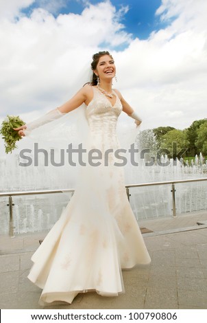 Bride on the background of the fountain and the sky