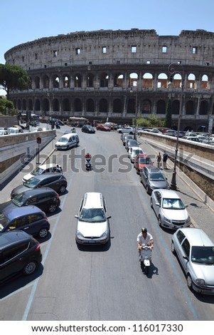 ROME, ITALY - JULY 10: Cars in front of Colosseum in Rome on July 10, 2012 in Rome, Italy. Experts say ancient building has started to tilt and may need urgent repairs.