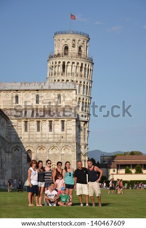 PISA, ITALY - JULY 16: Tourists posing in front of the Leaning tower of Pisa on July 16 2012 in Pisa, Italy.