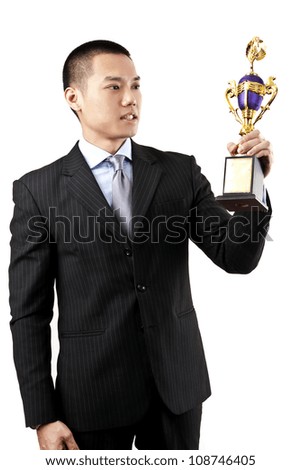 Asian businessman holding a trophy on white background