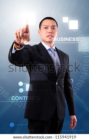 Asian business man touching an imaginary screen or button on visual screen