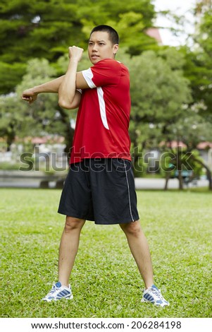Asian fitness man stretching at the park - fitness concepts sports exercises.