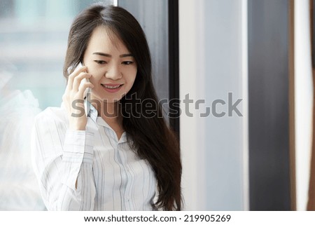 Close up young business woman speaking mobile phone.