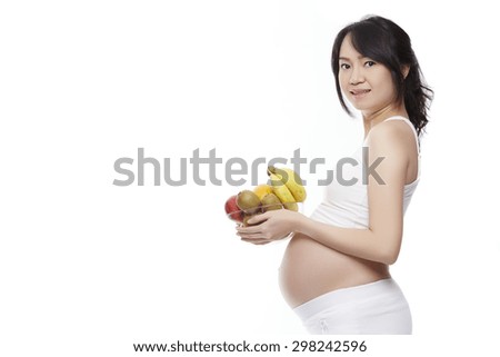 Pregnancy and nutrition - pregnant woman with fruits bowl on isolate white background.