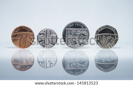 UK Currency Coins balanced in a row